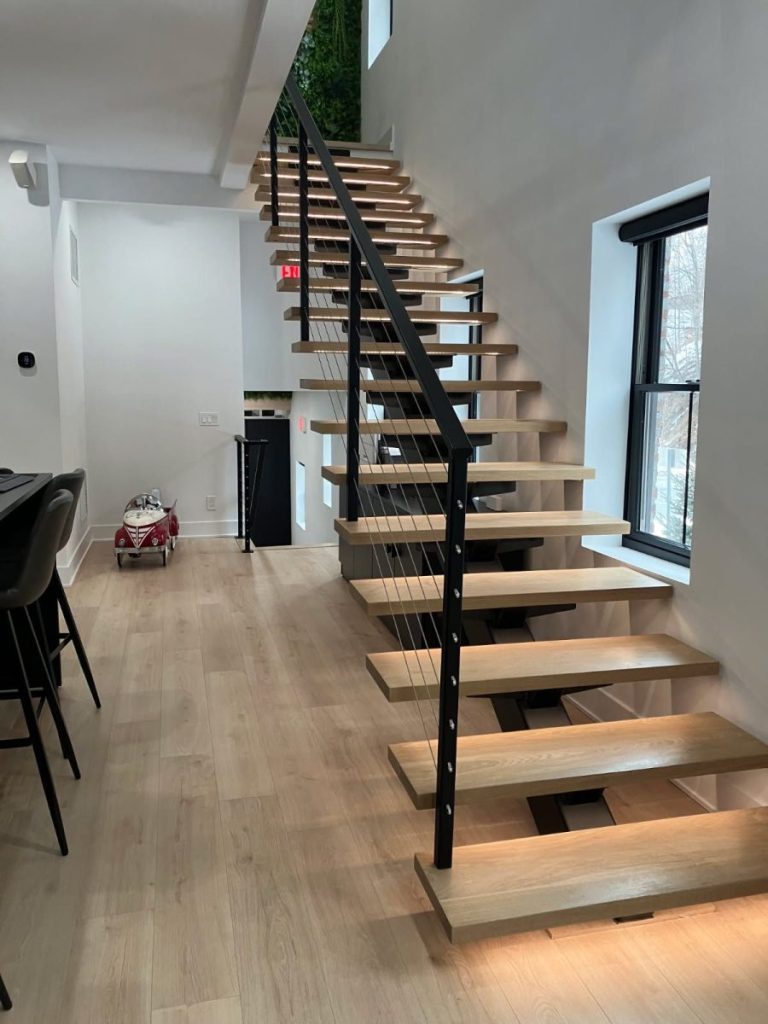 Custom built straight stairs - 6x8" steel tube single stringer with carriers under the treads and LED system.
Steel railing with our custom cable railing system. All steel powder coated satin black.
